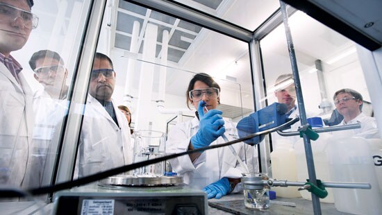 Scientists gathered around an experiment