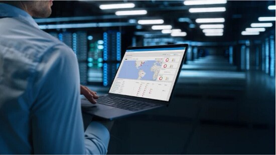 person with laptop in data center
