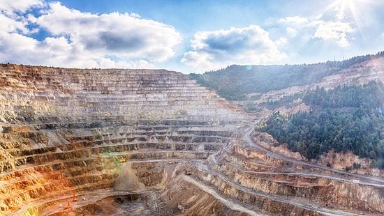 Open pit mine on sunny day